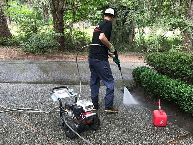 cleaning driveway with power washer