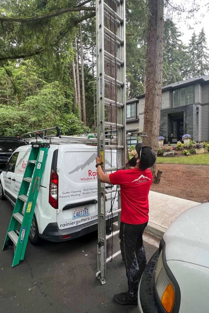 Rainier Gutter and Window Cleaning ladder onto work truck