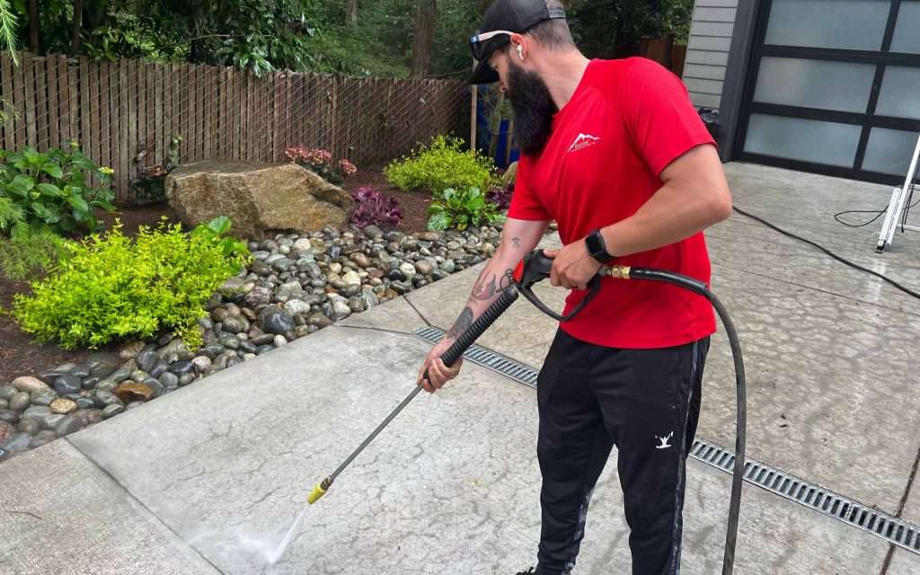 Rainier uses strong water pressure washer to remove grim on driveway